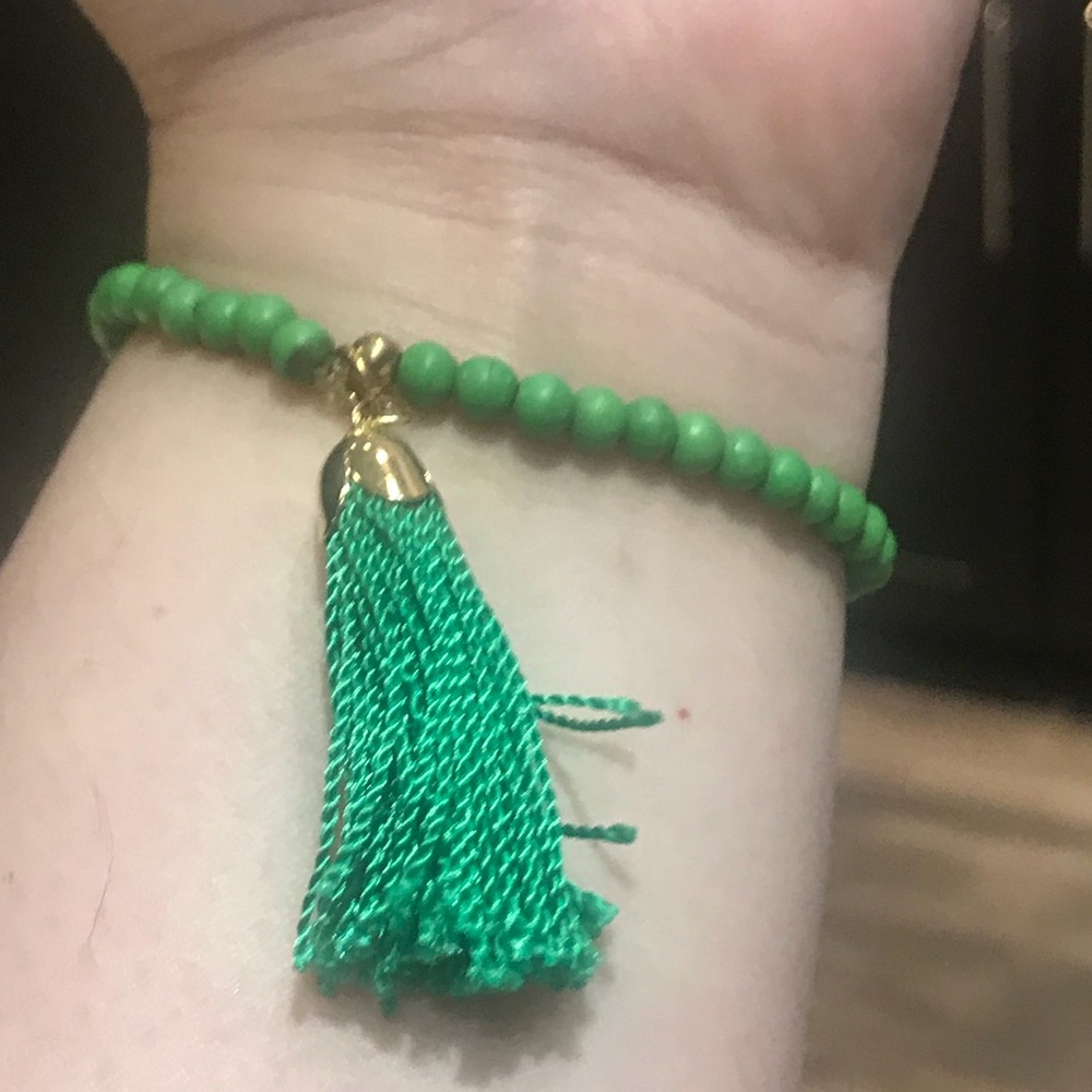 Green beaded bracelet with tassel